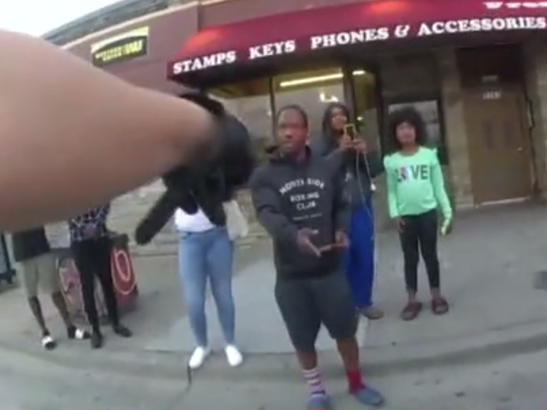 Officer Tou Thao as he told onlookers to stay on the pavement as George Floyd was arrested: (Minneapolis Police Department)