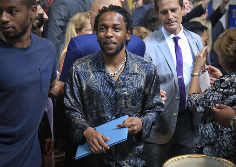 FILE - In this May 30, 2018 file photo, Kendrick Lamar holds a certificate after winning the Pulitzer Prize for music for his album "DAMN," during the 2018 Pulitzer Prize awards luncheon at Columbia University in New York. (AP Photo/Bebeto Matthews, File)