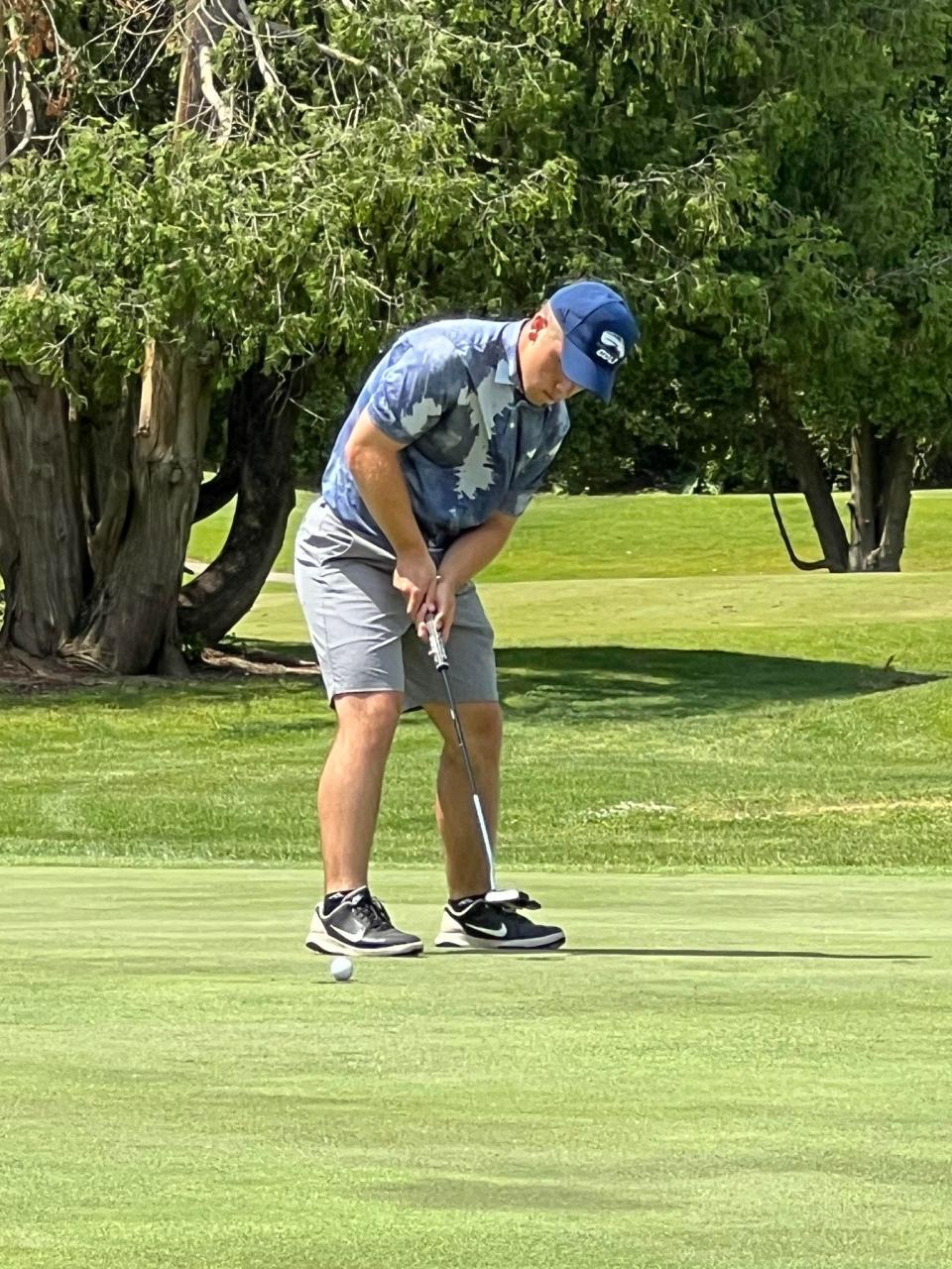 Ridley Fast sinks one of his two birdie shots at their regional finals event.