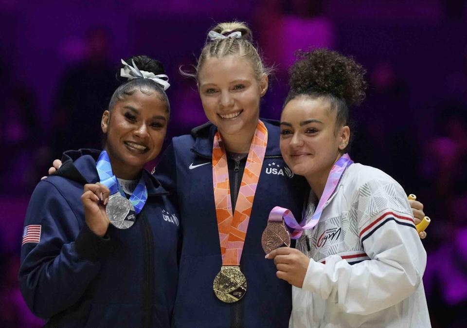 Winners of the women's vault finals, silver medallist Jordan Chiles of the U.S., left, gold medallist compatriot Jade Carey, center, and bronze medallist Coline Devillard, from France, celebrate during the Artistic Gymnastics World Championships at M&S Bank Arena in Liverpool, England, Saturday, Nov. 5, 2022. (AP Photo/Thanassis Stavrakis)