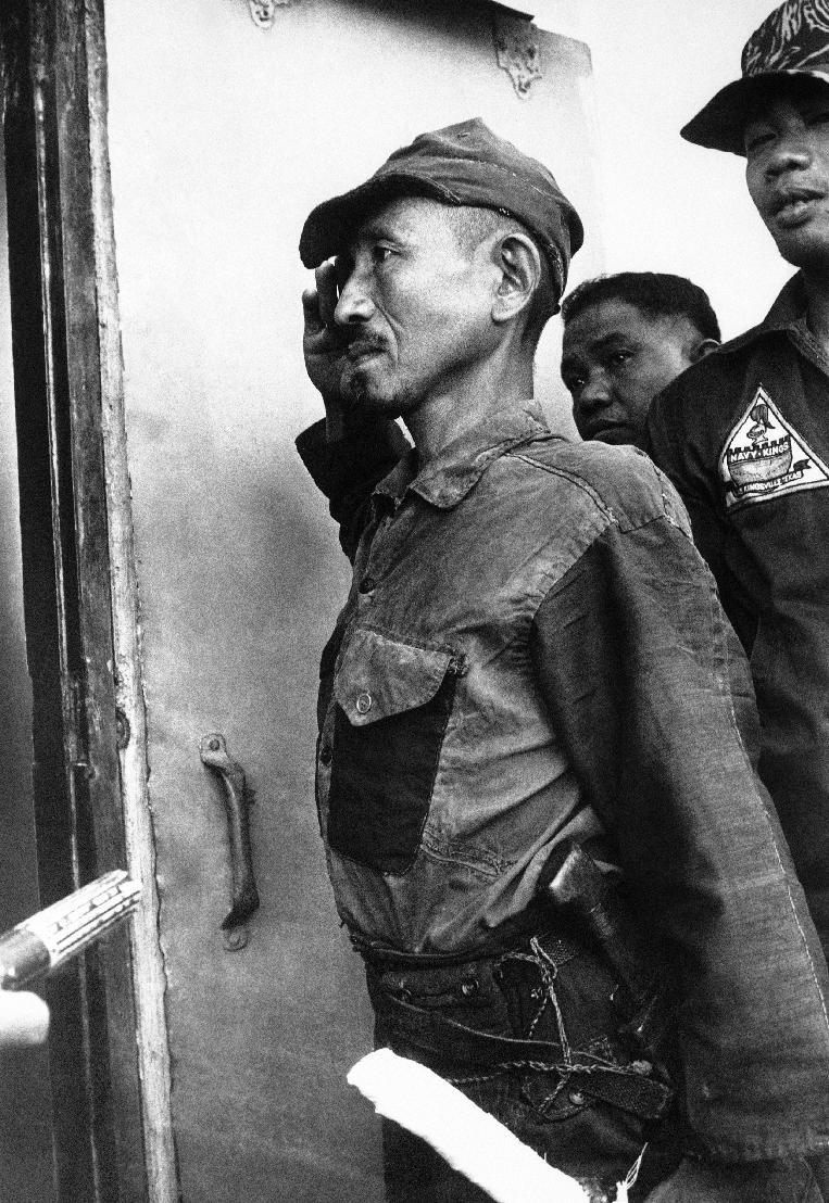 FILE - In this March 10, 1974 file photo, Hiroo Onoda, wearing his 30-year-old imperial army uniform, cap and sword, salutes to the Philippine Air Force on arrival at a radar site on Lubang Island, Philippines, when he comes out of hiding in the jungle. Onoda, the last Japanese imperial soldier to emerge from hiding and surrender after World War II, has died. He was 91. Onoda died Thursday, Jan. 16, 2014 at a Tokyo hospital. (AP Photo/File)