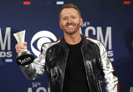 54th Academy of Country Music Awards- Photo room - Las Vegas, Nevada, U.S., April 7, 2019 - Shane McAnally poses backstage with his Songwriter of the Year award. REUTERS/Steve Marcus