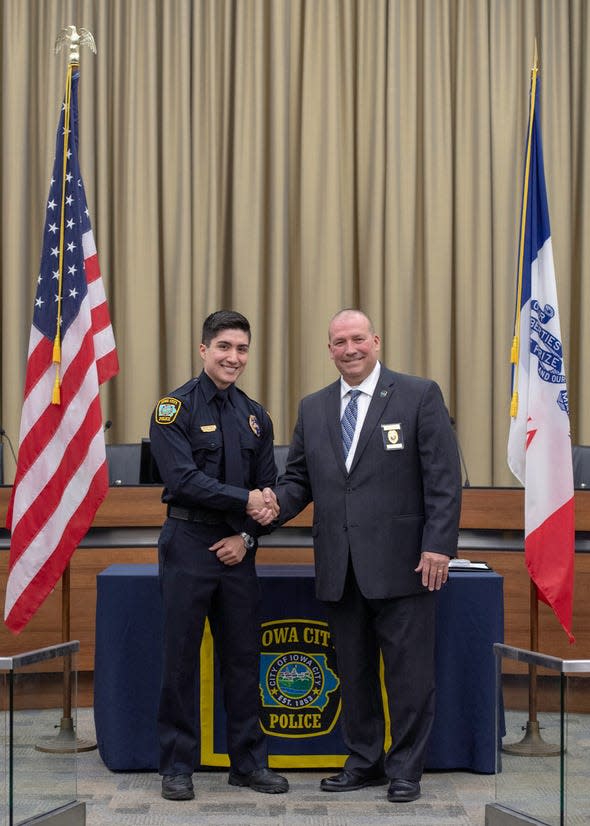Former ICPD officer Emilio Puente, left, shakes hands with former Police Chief Jody Matherly after being sworn in on April 24, 2019.