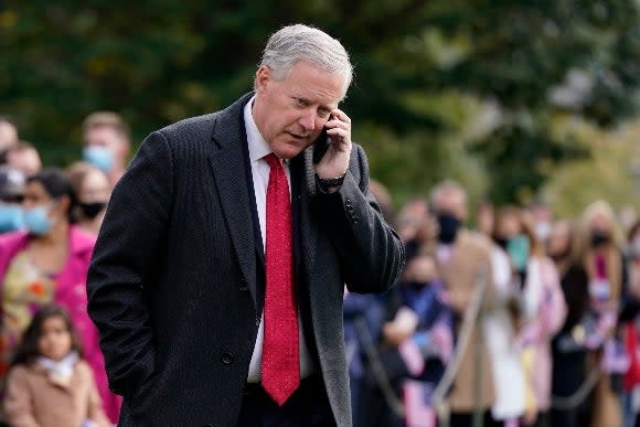 White House chief of staff Mark Meadows speaks on a phone on the South Lawn of the White House in Washington, on Oct. 30, 2020
