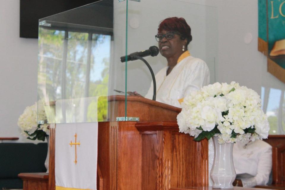 The Rev. Dr. Marie Herring, pastor of DaySpring Baptist Church, congratulates church members who were elevated and consecrated during a convocation service at the church on Sunday.