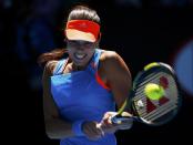 Ana Ivanovic of Serbia hits a return to Eugenie Bouchard of Canada during their women's quarter-final tennis match at the Australian Open 2014 tennis tournament in Melbourne January 21, 2014. REUTERS/Petar Kujundzic (AUSTRALIA - Tags: SPORT TENNIS)