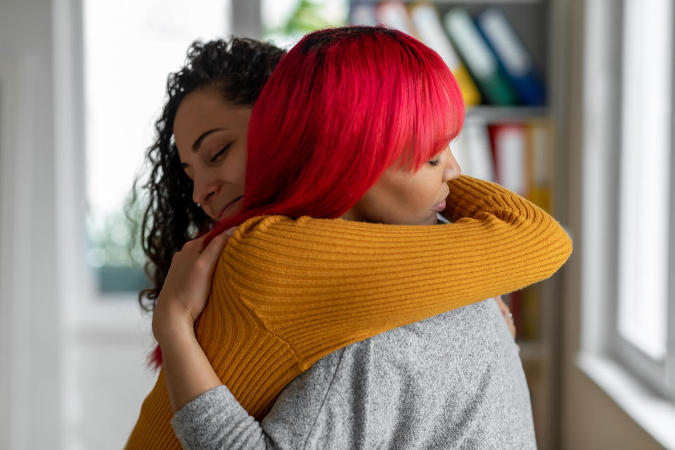 two female friends hugging