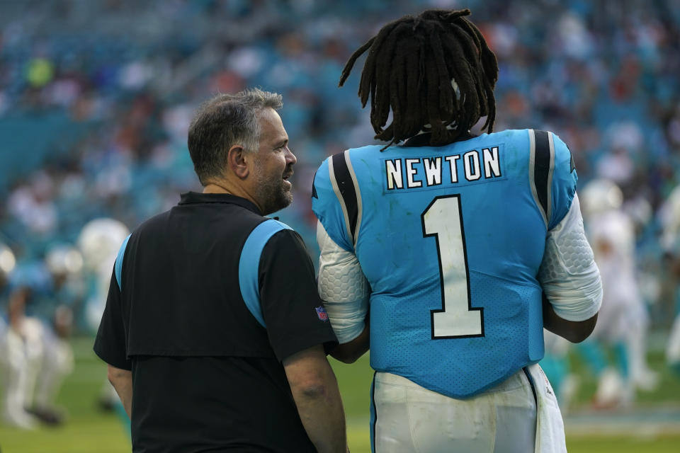 Carolina Panthers head coach Matt Rhule talks to quarterback Cam Newton (1) on the sideline after Newton came out during the second half of an NFL football game against the Miami Dolphins, Sunday, Nov. 28, 2021, in Miami Gardens, Fla. (AP Photo/Lynne Sladky)