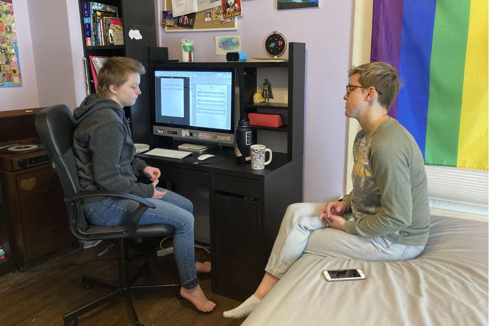 FILE - In this Feb. 23, 2021, file photo, Graciela Leahy, 13, an eighth grader at Ohio's Columbus Gifted Academy, talks with her mother, Elisa Leahy, right, in her bedroom, in Columbus, Ohio. At a year into the pandemic, the unplanned experiment with distance learning continued for thousands of students like Leahy before they set foot back in classrooms. Moves reflecting takeaways from pandemic experiences are being incorporated into many teacher preparation programs. Digital tools, online instruction, mental and emotional wellness are happening not just in what aspiring educators are learning, but how. More programs are using tools such as computer simulation training and virtual field supervision of student-teaching. (AP Photo/Kantele Franko, File)