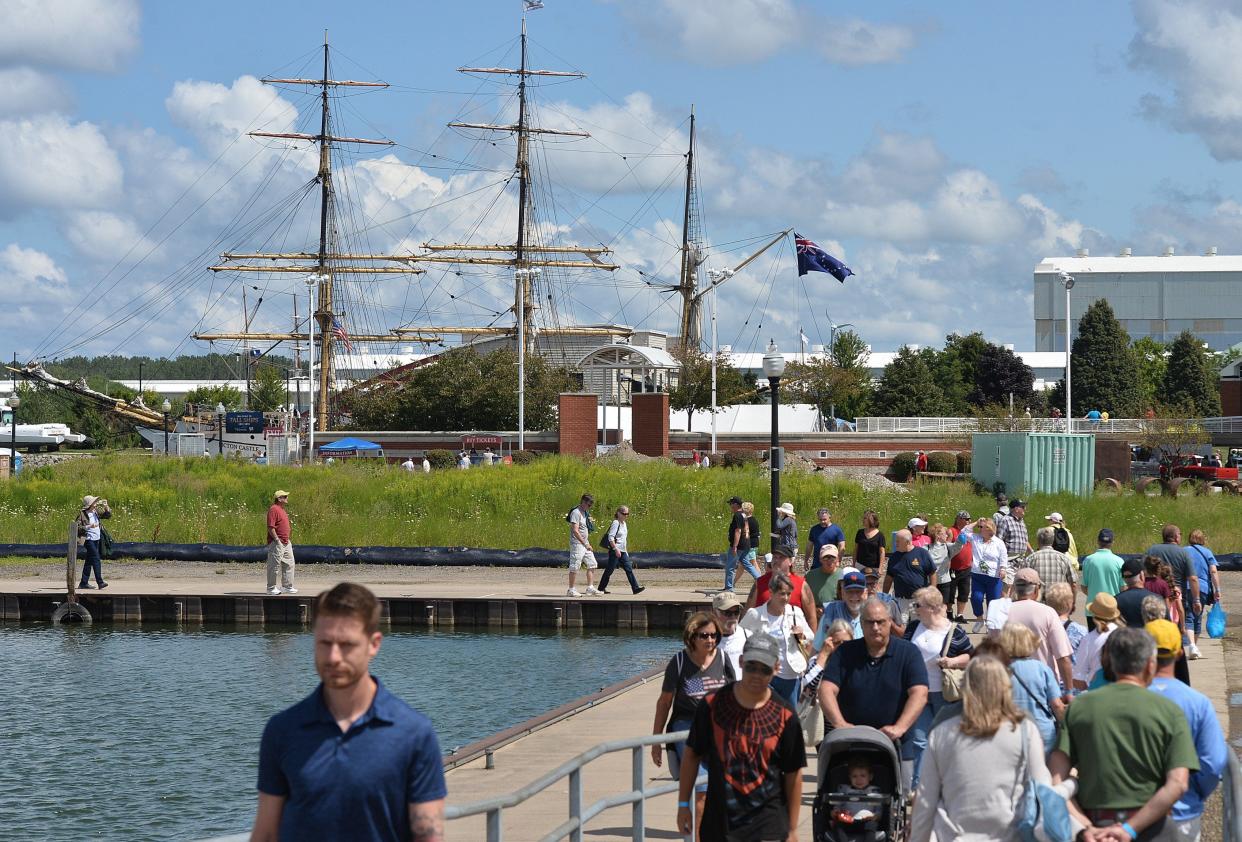 Visitors walk between tall ships docked around Dobbins Landing on Presque Isle Bay in 2019. Tall Ships Erie will return Aug. 25-28, 2022