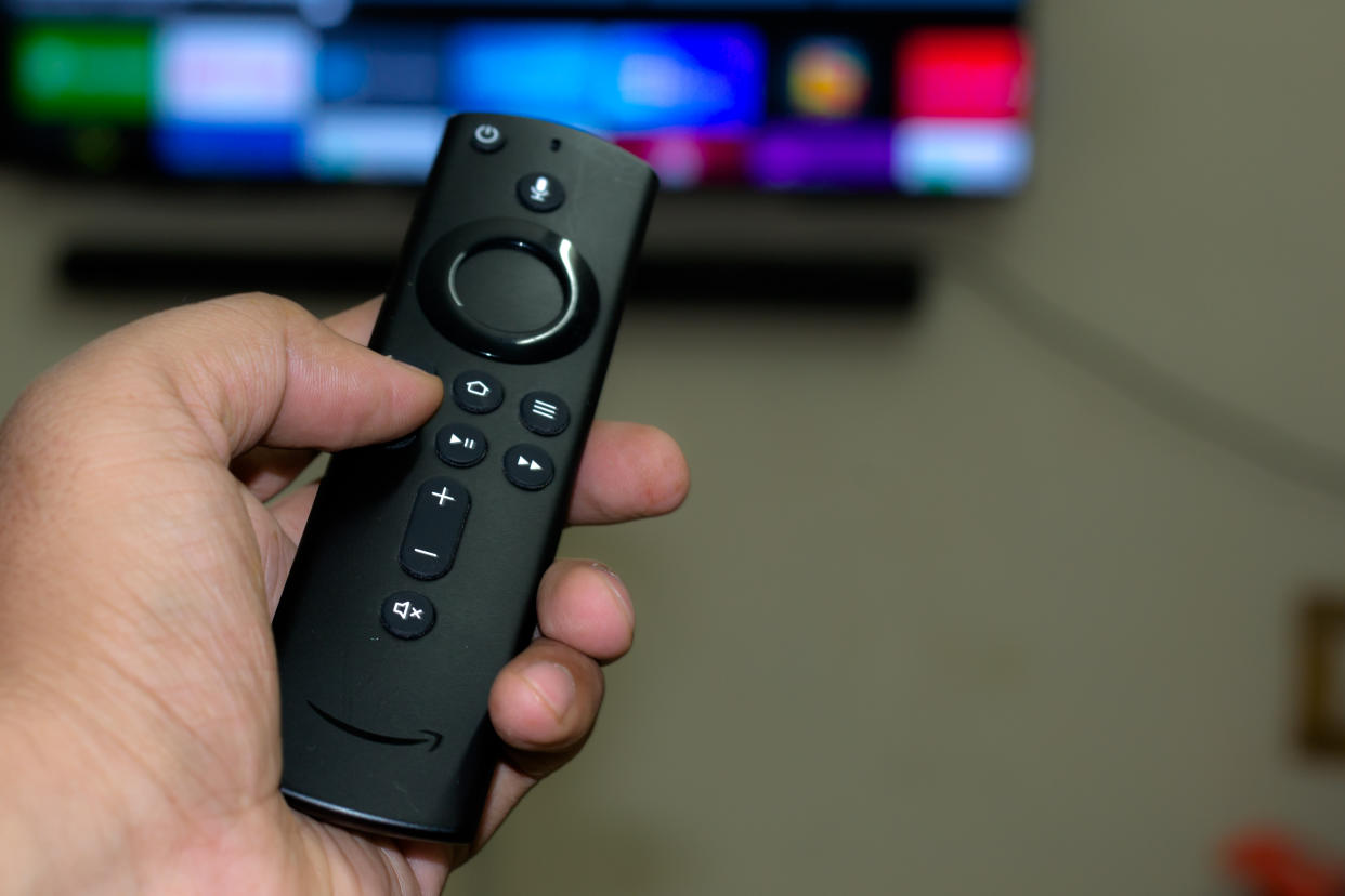 Amazon fire stick TV remote in hand