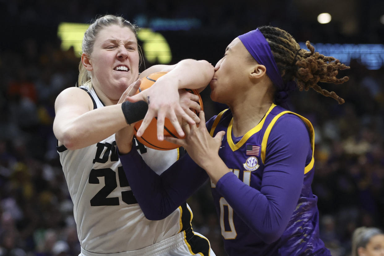 Apr 2, 2023; Dallas, TX, USA; Iowa Hawkeyes forward Monika Czinano (25) and LSU Lady Tigers forward LaDazhia Williams (0) battle for the ball in the first half during the final round of the Women's Final Four NCAA tournament at the American Airlines Center. Mandatory Credit: Kevin Jairaj-USA TODAY Sports