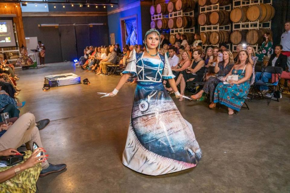 Edelweiss Vogel created this 2022 Upcycled Fashion Dress. It’s made from billboard art created by Caroline Rust. The model is Vogel's sister, Eilleen De Guzman, who also will model Vogel's design at this year's show. Alex Cason