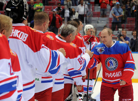 Russian President Vladimir Putin shakes hands with participants of a gala game of the Night Ice Hockey League in Sochi, Russia, May 10, 2016. Mikhail Klimentyev/Sputnik/Kremlin via Reuters