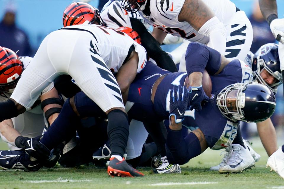 Tennessee Titans running back Derrick Henry (22) picks up a first down during the first quarter of an AFC divisional playoff game at Nissan Stadium Saturday, Jan. 22, 2022 in Nashville, Tenn.