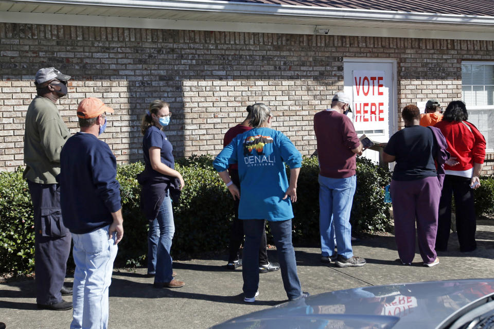 FILE - In this Nov. 3, 2020, file photo, voters stand in line as they wait to cast their ballots on Election Day in Notasulga, Ala. Voters in Colorado, Florida and Alabama passed ballot measures Tuesday that codify what is already law: That only U.S. citizens 18 and older can vote. The passage of the largely-symbolic measures has triggered questions about why the pro-Trump group behind them spent time and money on the effort. The amendments passed overwhelmingly in all three states. (AP Photo/Butch Dill, File)