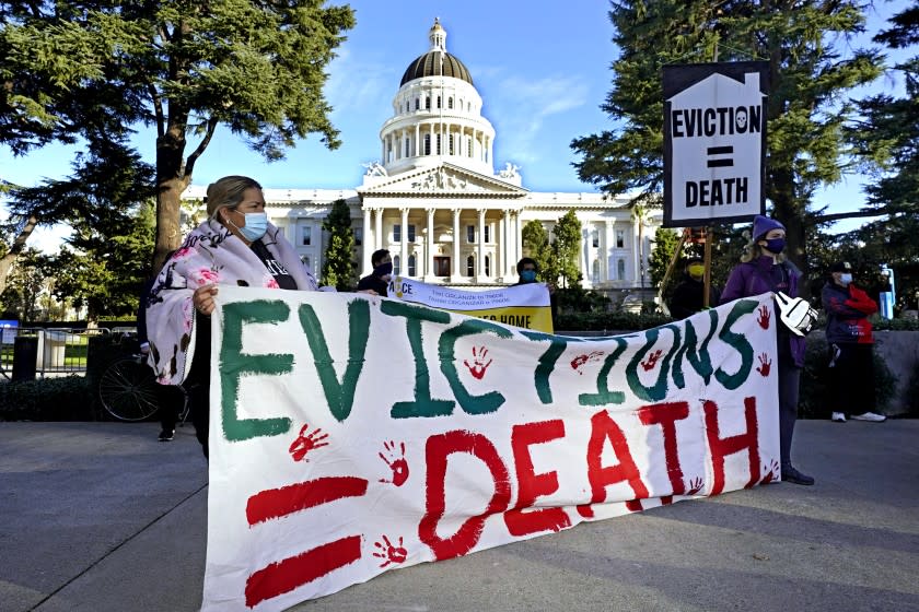 Demonstrators calling for lawmakers and Gov. Gavin Newsom to pass rent forgiveness and stronger eviction protections legislation, gather in front of the Capitol in Sacramento, Calif., on Monday, Jan. 25, 2021. Gov. Gavin Newsom, Assembly Speaker Anthony Rendon and Senate President Pro Tempore Toni Atkins announced a proposal that would extend pandemic eviction protections through the end of June and pay up to 80% of some tenants' unpaid rent as long as landlords agreed to forgive the remaining 20%. The proposal must still be approved by the state Legislature. (AP Photo/Rich Pedroncelli)