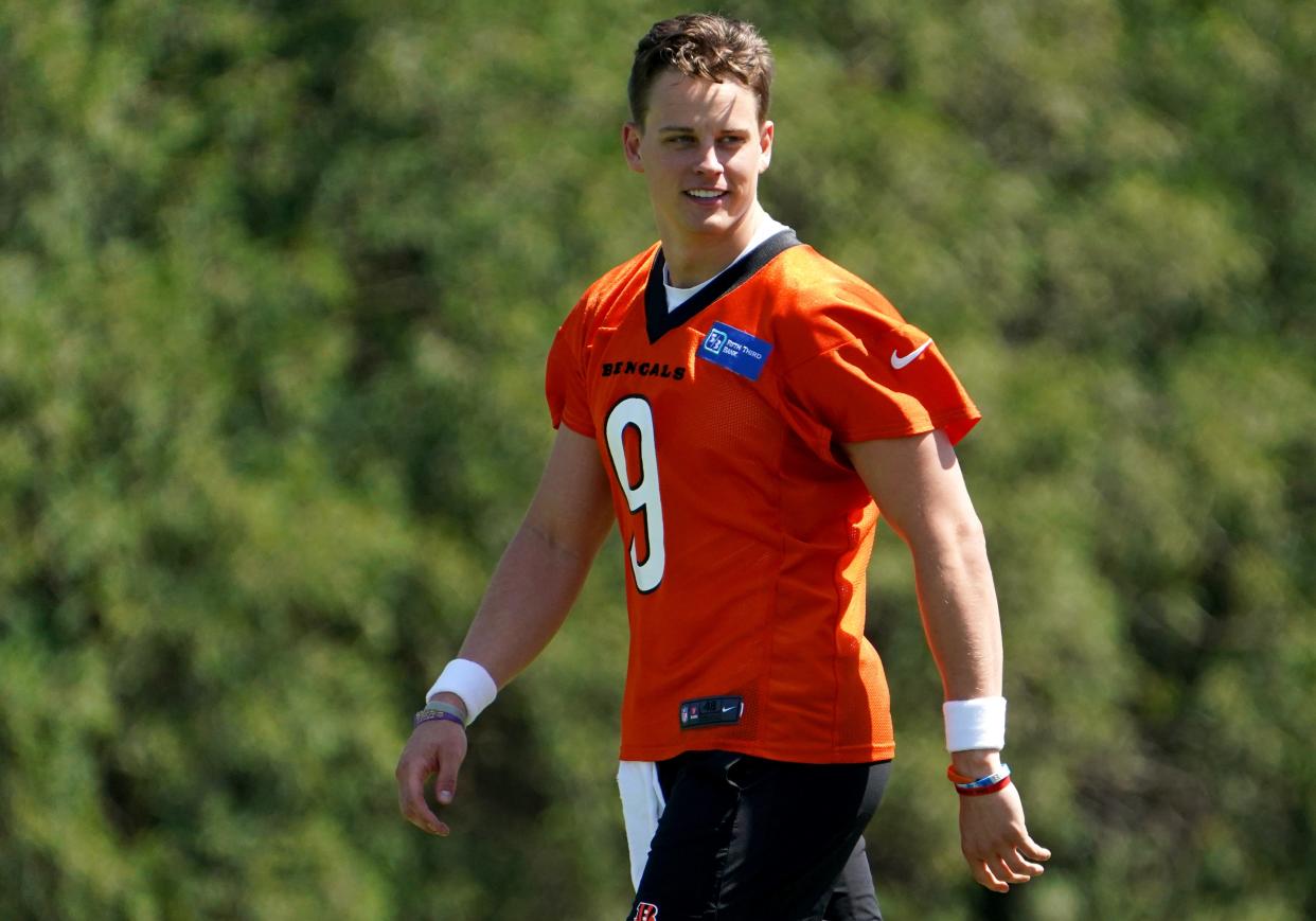 Cincinnati Bengals quarterback Joe Burrow (9) smiles during practice, Tuesday, May 17, 2022, at the Paul Brown Stadium practice fields in Cincinnati. 