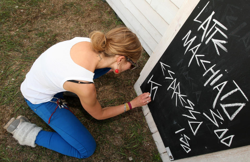 BERLIN, GERMANY - JULY 21: An employee writes out a coffee menu at the second annual Hipster Olympics on July 21, 2012 in Berlin, Germany. With events such as the "Horn-Rimmed Glasses Throw," "Skinny Jeans Tug-O-War," "Vinyl Record Spinning Contest" and "Cloth Tote Sack Race," the Hipster Olympics both mocks and celebrates the Hipster subculture, which some critics claim could never be accurately defined and others that it never existed in the first place. The imprecise nature of determining what makes one a member means that the symptomatic elements of adherants to the group vary in each country, but the archetype of the version in Berlin, one of the more popular locations for those following its lifestyle, along with London and Brooklyn, includes a penchant for canvas tote bags, the carbonated yerba mate drink Club Mate, analogue film cameras, asymetrical haircuts, 80s neon fashion, and, allegedly, a heavy dose of irony. To some in Berlin, members of the hipster "movement" have replaced a former unwanted identity in gentrifying neighborhoods, the Yuppie, for targets of criticism, as landlords raise rents in the areas to which they relocate, particularly the up-and-coming neighborhood of Neukoelln. (Photo by Adam Berry/Getty Images)