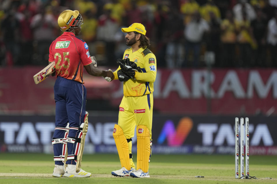 Chennai Super Kings' MS Dhoni, right, shakes hands with Punjab Kings' Kagiso Rabada after Chennai Super Kings won their Indian Premier League cricket match against Punjab Kings in Dharamshala, India, Sunday, May 5, 2024. (AP Photo /Ashwini Bhatia)