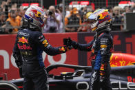 Red Bull driver Max Verstappen of the Netherlands, right, congratulates third placed Red Bull driver Sergio Perez of Mexico after winning the Chinese Formula One Grand Prix at the Shanghai International Circuit, Shanghai, China, Sunday, April 21, 2024. (AP Photo/Andy Wong)