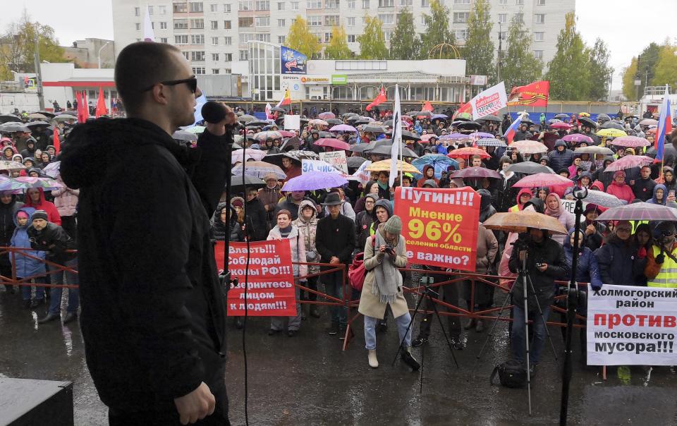 People listen to a speaker during a rally against plans for the waste plant in a pristine Russian forest has gained national prominence, in Arkhangelsk, Russia, Sunday, Sept. 22, 2019. Several thousand people have taken to the streets across northwest Russia to protest a controversial plan to build a major waste plant there. (AP Photo/Ilya Leonyuk)