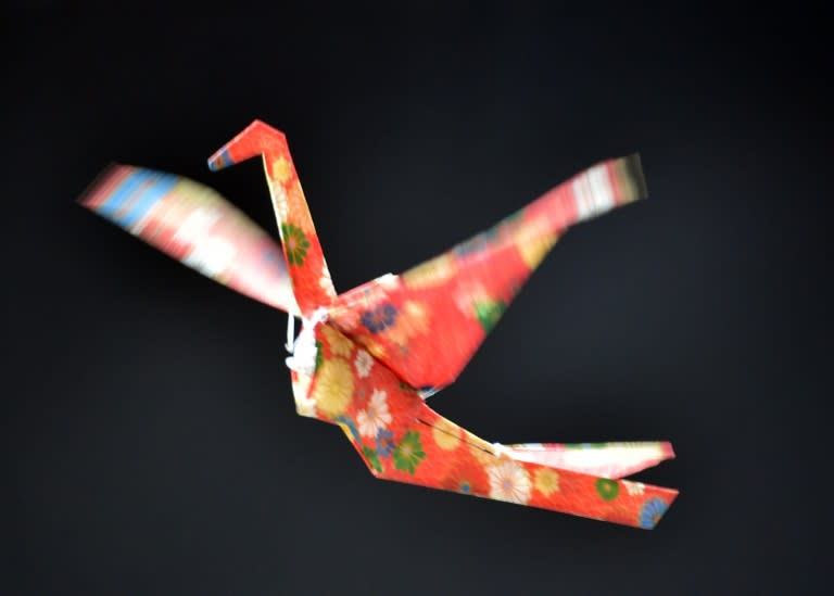 Japan's electronics maker Rohm demonstrate a remote controlled flying paper crane, during a preview of Asia's largest electronics trade show CEATEC, in Chiba, suburban Tokyo, on October 6, 2015
