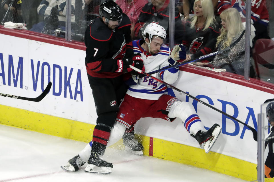 Carolina Hurricanes defenseman Brendan Smith (7) checks New York Rangers center Filip Chytil (72) during the first period during Game 2 of an NHL hockey Stanley Cup second-round playoff series Friday, May 20, 2022, in Raleigh, N.C. (AP Photo/Chris Seward)