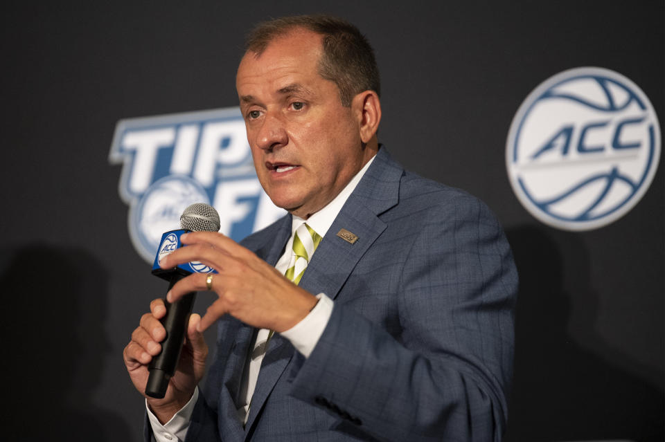 FILE - Atlantic Coast Conference Commissioner Jim Phillips speaks during NCAA college basketball ACC media day, Tuesday, Oct. 12, 2021, in Charlotte, N.C. The Atlantic Coast Conference will hold five straight men’s basketball tournaments in North Carolina starting in 2025, while the women’s tournament that has had a longtime home in Greensboro as the city of the league’s founding will split time between there and Charlotte.(AP Photo/Matt Kelley, File)