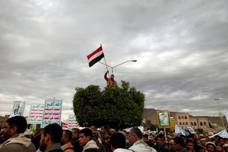 FILE PHOTO - A boy holds a flag as supporters of the Houthi movement attend a pro-Houthi rally in Sanaa, Yemen February 17, 2017. REUTERS/Mohammed al-Sayaghi