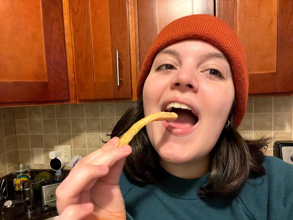 Gabi Stevenson eating a french fry with mayo-ketchup on it