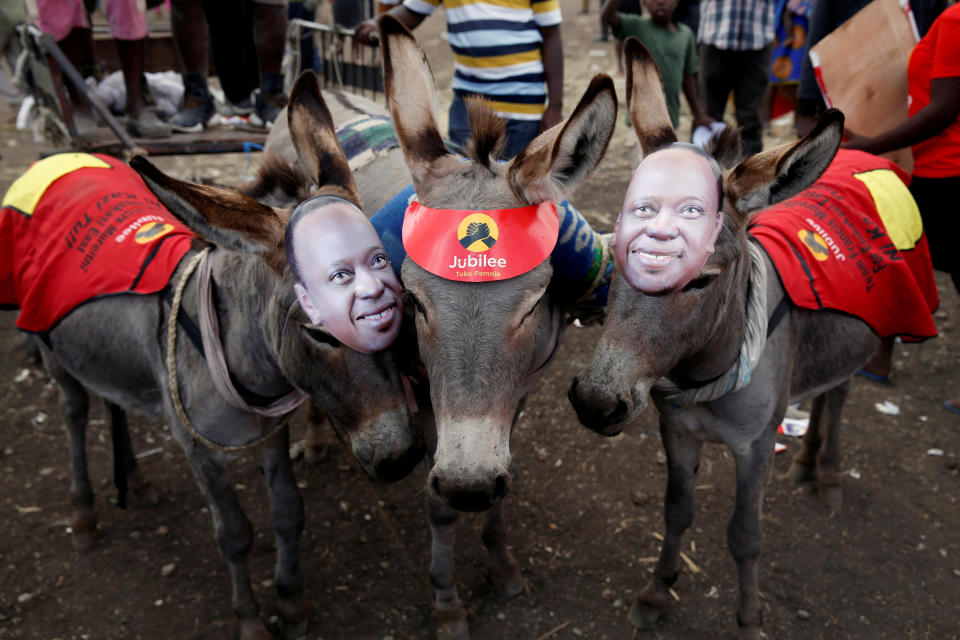 <p>Donkeys wearing masks depicting Kenya’s President Uhuru Kenyatta stand during a Jubilee Party election rally in Nairobi, Kenya, July 21, 2017. (Photo: Baz Ratner/Reuters) </p>