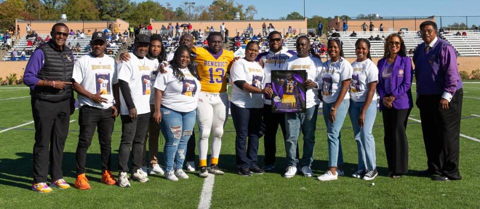 Benedict College’s Loobert Denelus poses for a photo with his family and Tigers’ coach Chennis Berry during Senior Day against Allen University last month.
