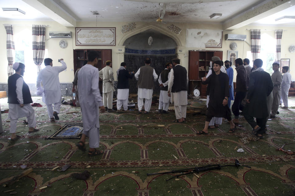 Afghans inspect the inside of a mosque following a bombing, in Kabul, Afghanistan, Friday, June 12, 2020. (AP Photo/Rahmat Gul)