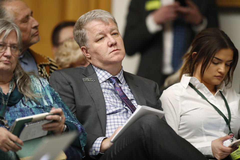 Dudley Brown, a gun right lobbyist and founder and executive director of Rocky Mountain Gun Owners, listens to testimony during a hearing before the House Judiciary Committee on a bill to get a 