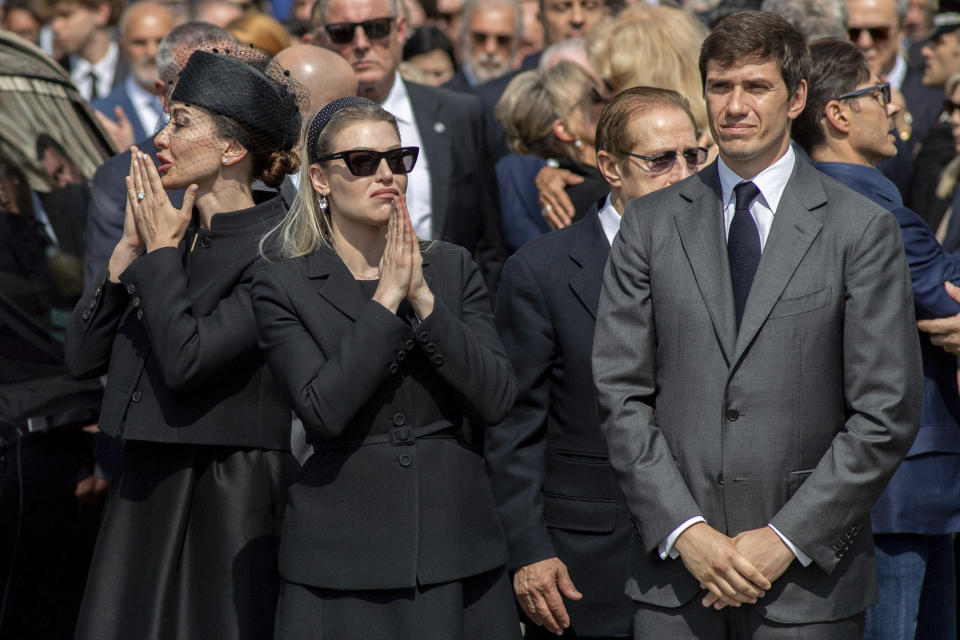 Family members of former Italian Premier Silvio Berlusconi, from left, daughters Eleonora and Barbara, and son Luigi, acknowledge the crowd at the end of Berlusconi's state funeral outside the Milan's Gothic Cathedral in northern Italy, Wednesday, June 14, 2023. Berlusconi died at the age of 86 on Monday in a Milan hospital where he was being treated for chronic leukemia. (Claudio Furlan/LaPresse via AP)