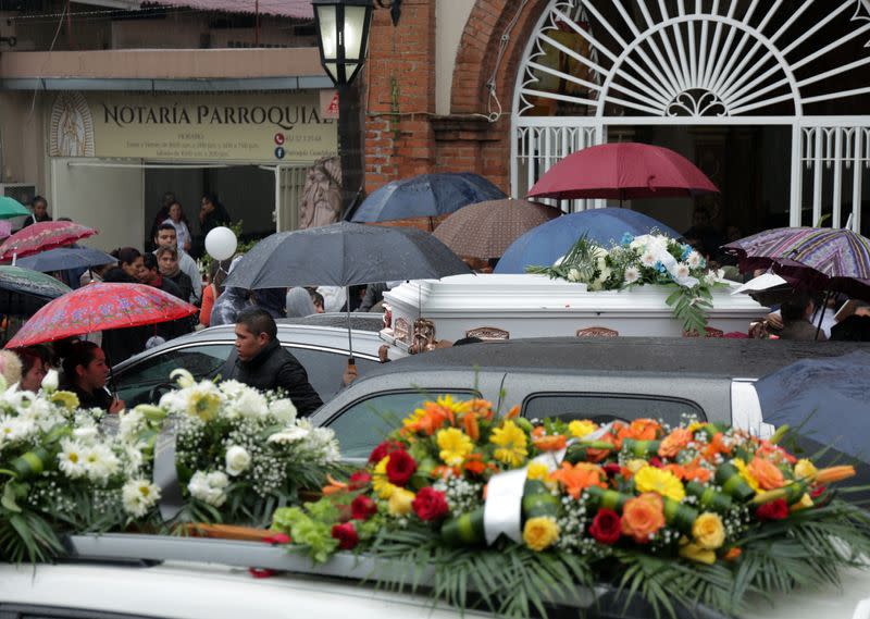 People attend the funeral of several of the victims killed by shooters at a slot-machine arcade in the central Mexican state of Michoacan, in Uruapan