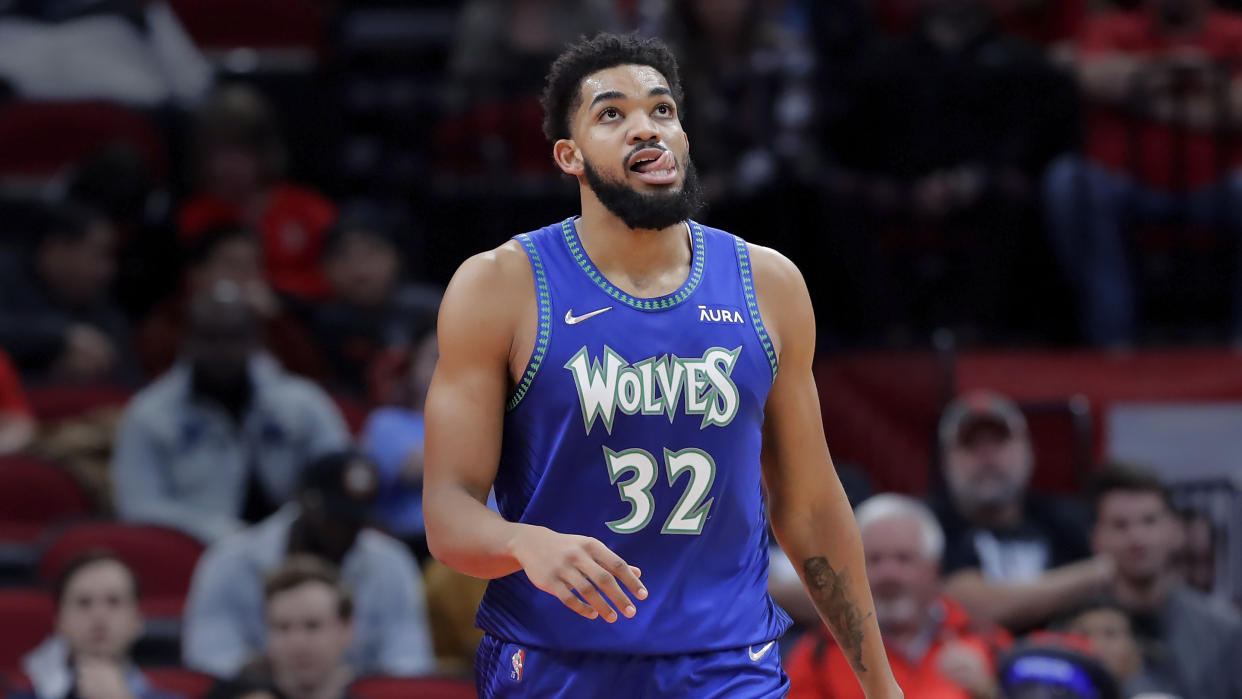 Minnesota Timberwolves center and Wordle fan Karl-Anthony Towns (32) during the second half of an NBA basketball game against the Houston Rockets Sunday, Jan. 9, 2022, in Houston. (AP Photo/Michael Wyke)