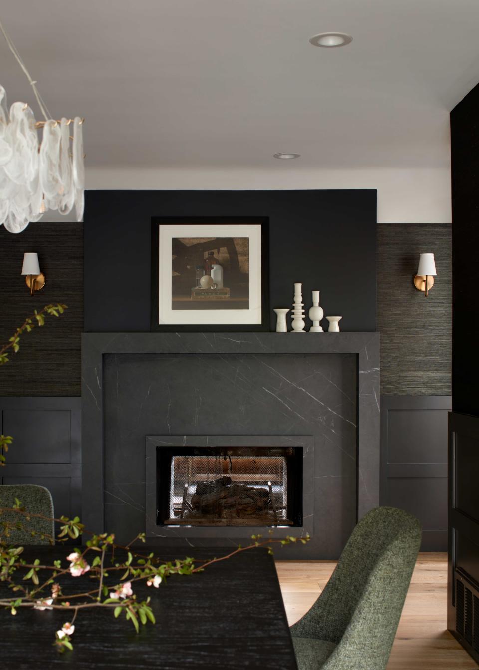 a fireplace surrounded by grasscloth wallpaper