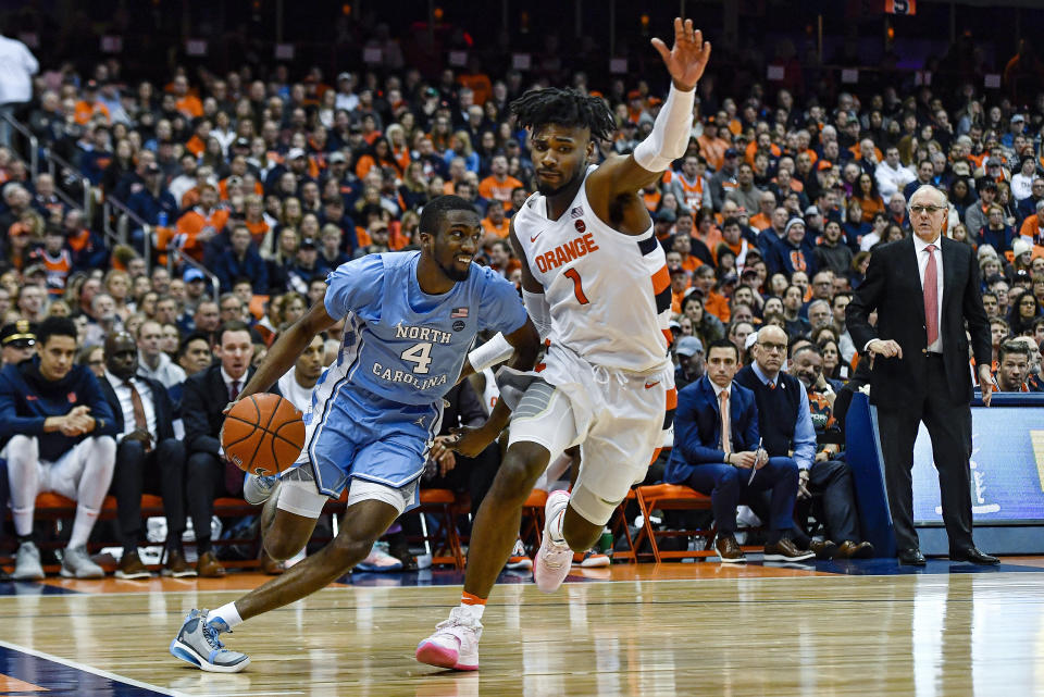 North Carolina guard Brandon Robinson, left, is defended by Syracuse forward Quincy Guerrier during the second half of an NCAA college basketball game in Syracuse, N.Y., Saturday, Feb. 29, 2020. North Carolina defeated Syracuse 92-79. (AP Photo/Adrian Kraus)