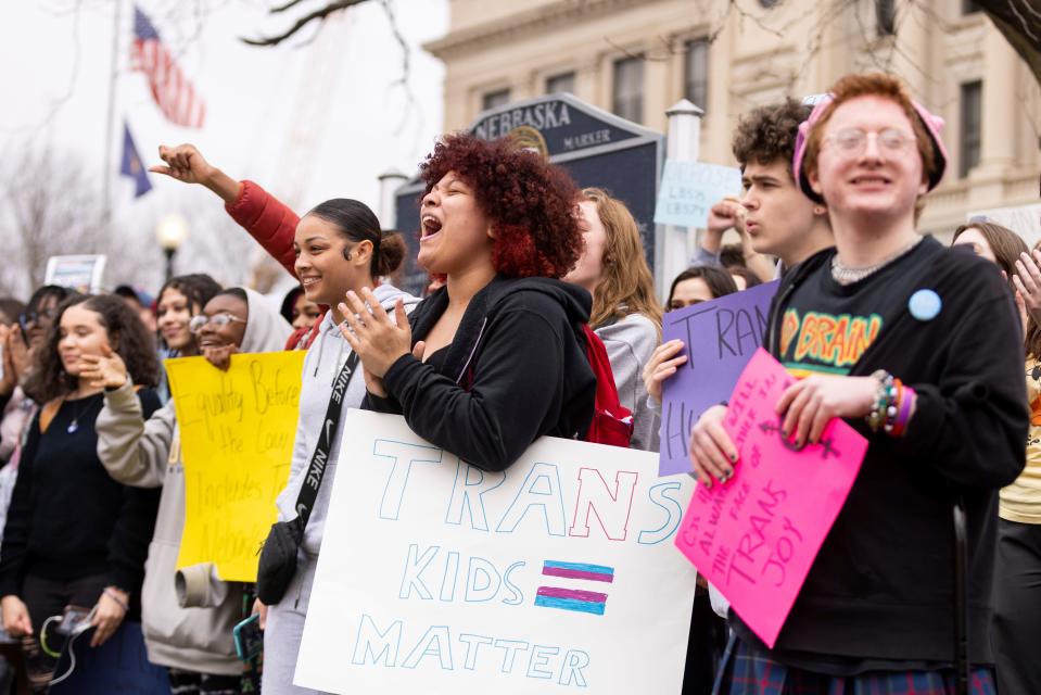 Mae Keller, a senior, carries a "Trans Kids Matter" sign and cheers as hundreds of students walk out of school on Transgender Day of Visibility outside Omaha Central High School Friday, March 31, 2023, in Omaha, Neb. Students are protesting LB574 and LB575 in the Nebraska Legislature, which would ban certain gender-affirming care for youth and would prevent trans youth from competing in girls sports, respectively.