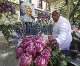 <p>Hiram Smith, owner of HiramStyle, prepares a floral arrangement around a portrait of former first lady Barbara Bush in the Barbara Bush Literacy Plaza on Thursday, April 19, 2018, in Houston. (Photo: Steve Gonzales/Houston Chronicle via AP) </p>