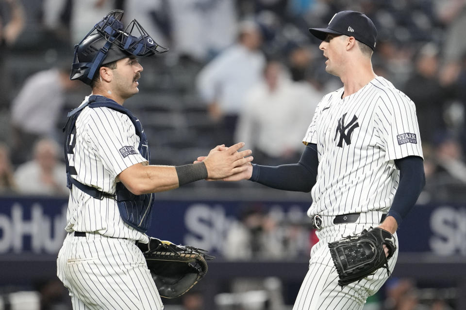 New York Yankees pitcher Clay Holmes, left, and catcher Austin Wells celebrate after defeating the Miami Marlins in a baseball game, Tuesday, April 9, 2024, in New York. The Yankees won 3-2. (AP Photo/Mary Altaffer)