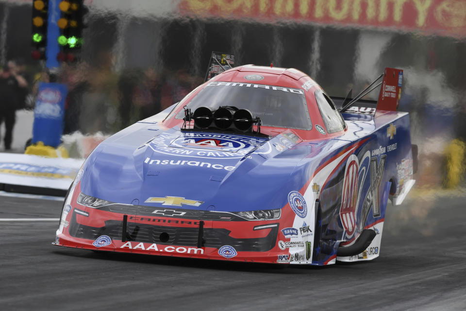 In this photo provided by the NHRA, Robert Hight tallies his fourth win at the at the Mopar Express Lane NHRA SpringNationals at Houston Raceway Park in Baytown, Texas, Monday, May 24, 2021, after rain on Sunday delayed racing. (Jerry Foss/NHRA via AP)