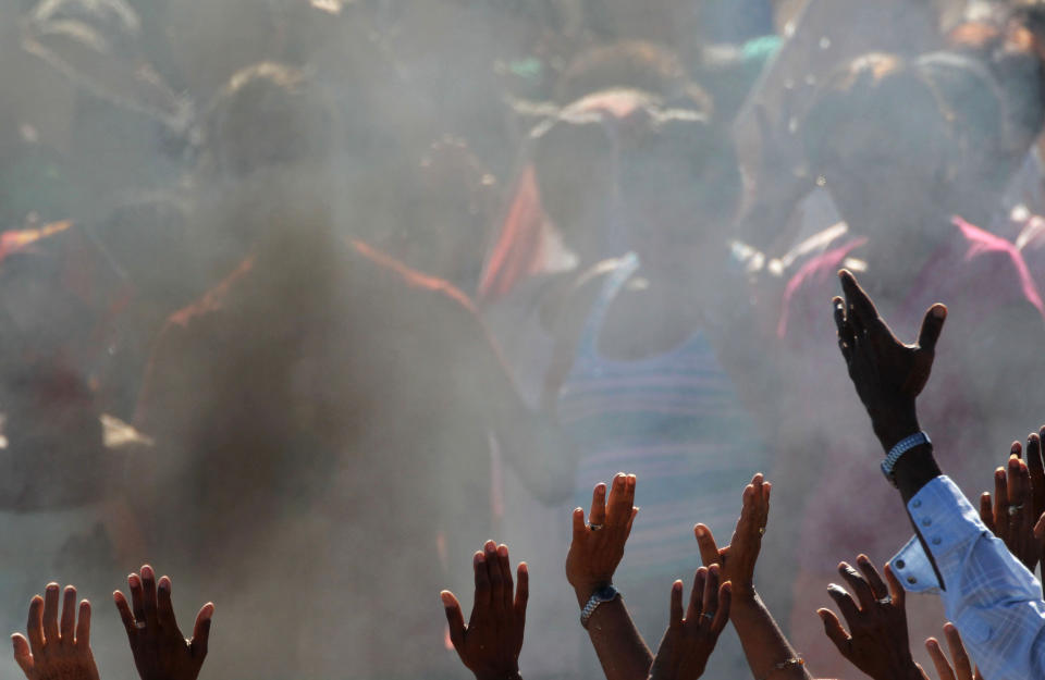 FILE - In this Dec. 6, 2012 file photo, people raise their hands during a ceremony by Mayan sages in Bacuranao, Cuba. From Russia to California, thousands are preparing for the fateful day, when many believe a 5,125-year cycle known as the Long Count in the Mayan calendar supposedly comes to an end. In Mexico's Mayan heartland, nobody is preparing for the end of the world; instead, they're bracing for a tsunami of spiritual visitors. Jose Manrique Esquivel, a descendent of the Maya, said his community in Mexico's Yucatan peninsula sees the date as a celebration of their survival despite centuries of genocide and oppression. He blamed profiteers looking to scam the gullible for stoking doomsday fears. (AP Photo/Ramon Espinosa, File)