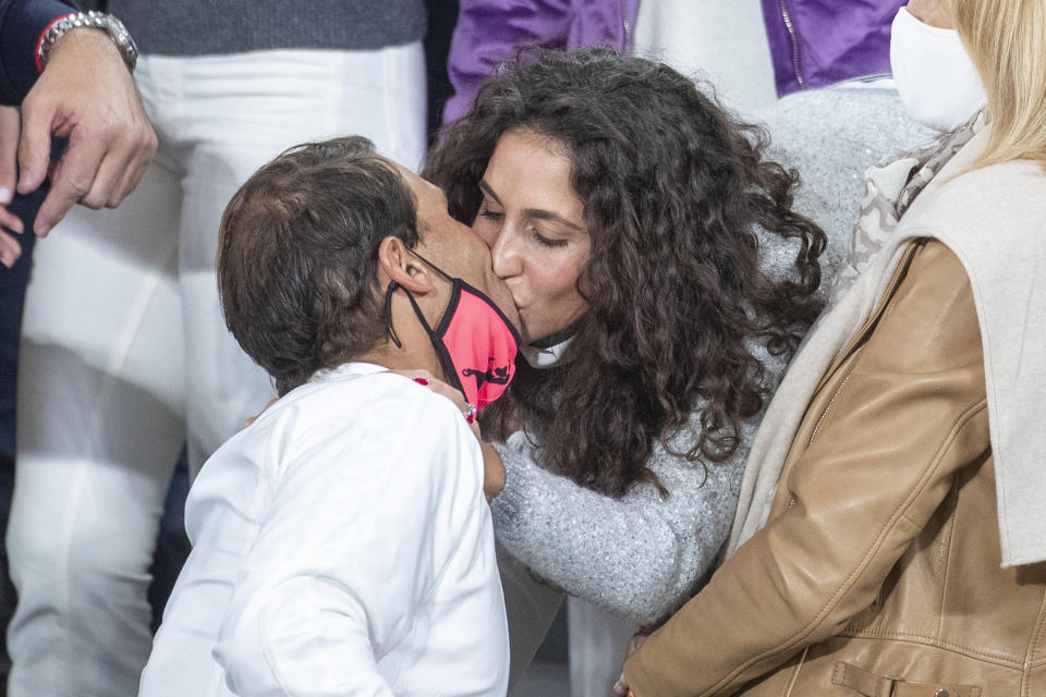 Rafael Nadal kisses his wife Xisca Perello at Roland Garros.