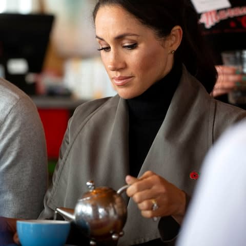 The Duchess of Sussex pours herself a tea - Credit: Ian Vogler