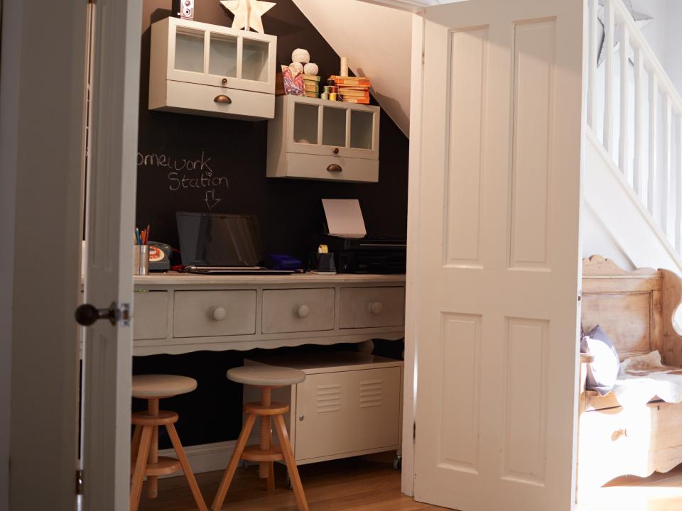 office hidden in a closet under the staircase