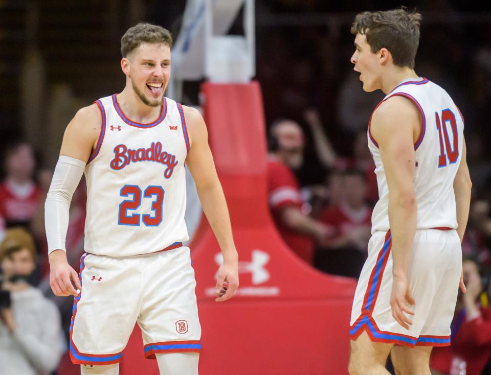 Bradley's teammates Ville Tahvanainen, left, and Connor Hickman celebrate one of Tahvanainen's five consecutive three-pointers against Murray State in the second half Saturday, Feb. 11, 2023 at Carver Arena. The Braves rolled over the Racers 83-48.