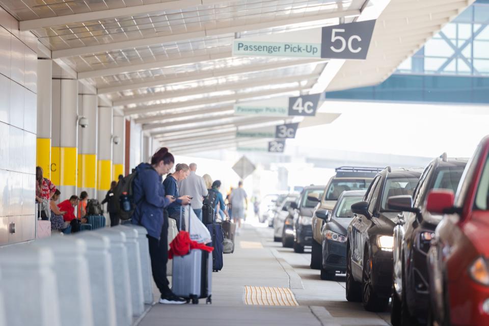 Travelers wait to be picked up at the Salt Lake City International Airport in Salt Lake City on Friday, May 19, 2023. | Ryan Sun, Deseret News